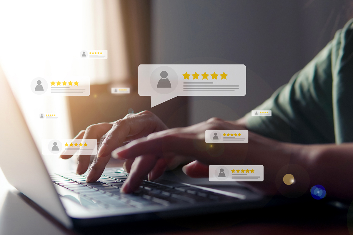 image of someone typing on laptop with customer review bubbles in the foreground highlighting the importance of understanding the customer experience