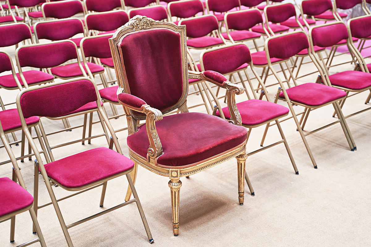 a pink throne sitting among a row of pink chairs illustrating the concept of routine extensions for product innovation