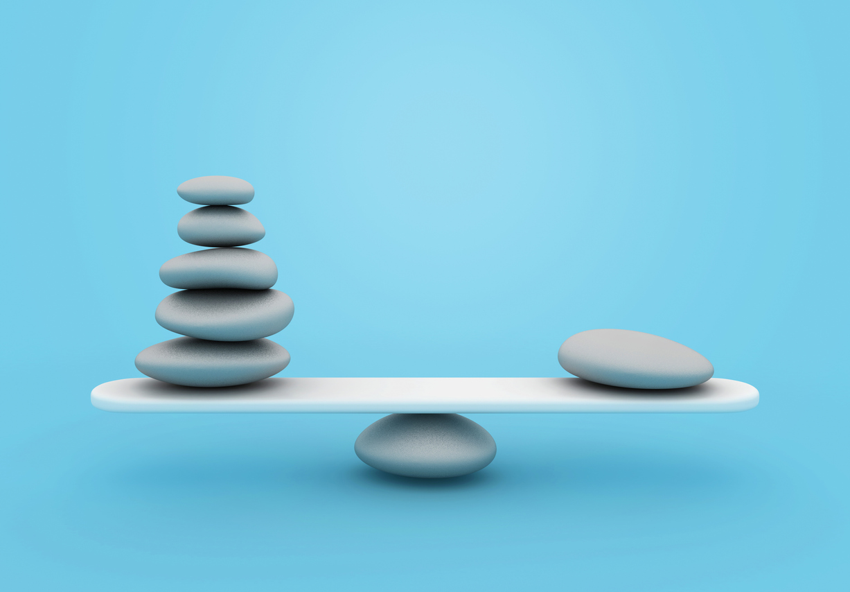 3D rendering of gray stones balanced on either end of a seesaw representing the positive impact of assessing brand health metrics.