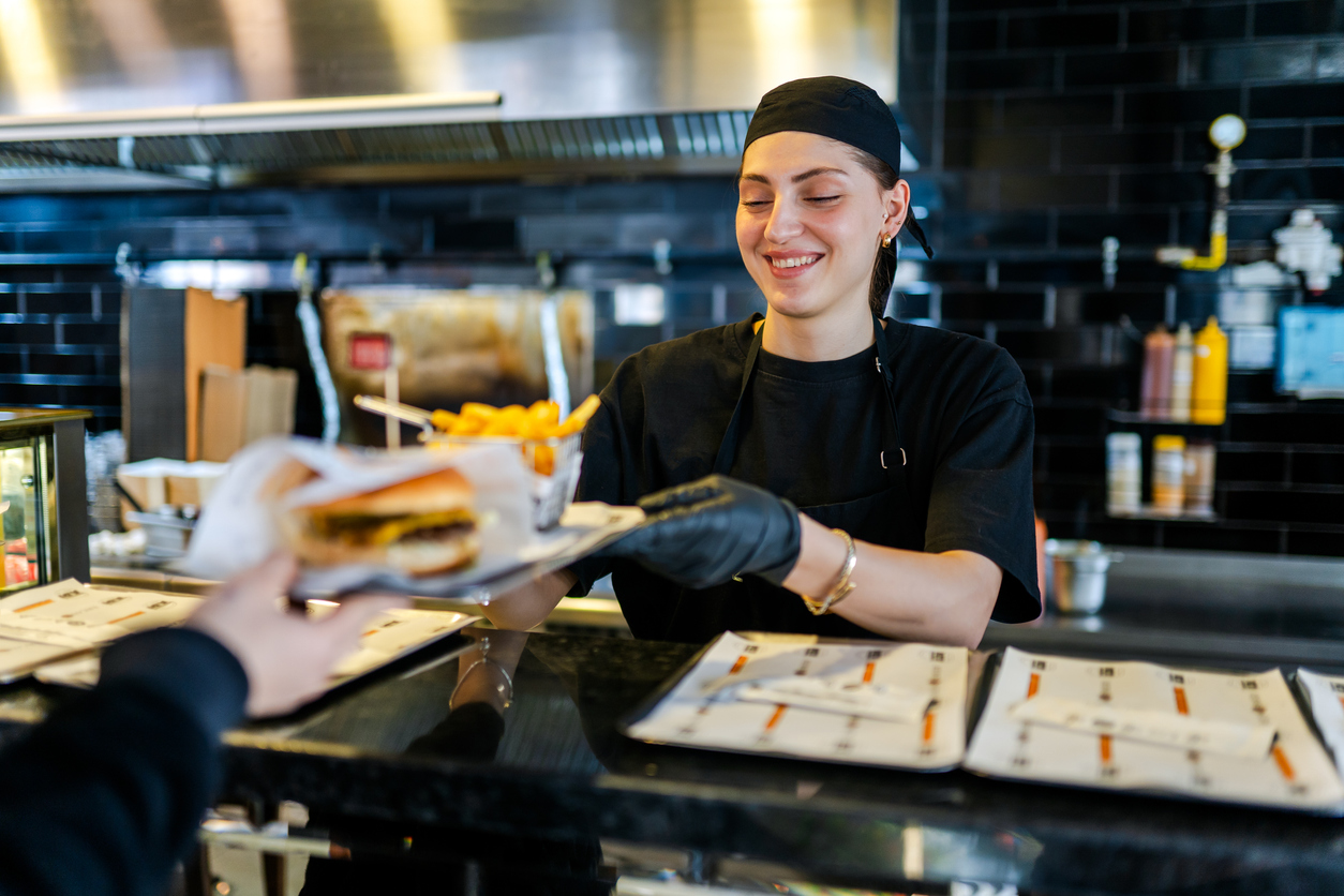 Young woman working at a quick service restaurant.