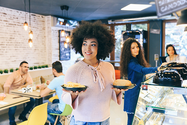 woman carrying food in a cafe