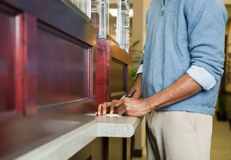 Customer going into bank branch to deposit check