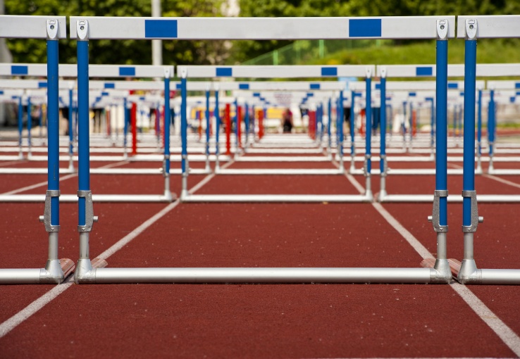 Hurdles lined up on a track to represent barriers to integrating text analytics into your business.
