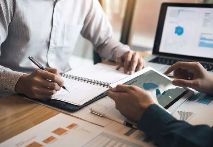 Professional and client at desk discussing finances