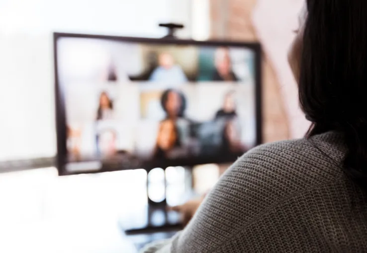 Blurred computer screen showing participants in a virtual focus group for market research purposes.